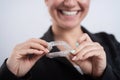A woman is holding a transparent plastic mouth guard. Orthodontist`s bite correction device Royalty Free Stock Photo