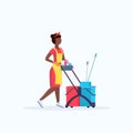 Woman holding trolley cart with supplies african american female cleaner janitor in uniform cleaning service concept