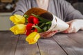 Woman holding tulips in craft paper