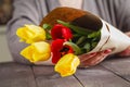 Woman holding tulips in craft paper