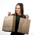 Woman is holding two grocery shopping bags on white background Royalty Free Stock Photo