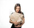 Woman is holding two grocery shopping bags on white background. Light brown paper bags in hands. Isolated background. Royalty Free Stock Photo