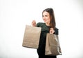 Woman is holding two grocery shopping bags on white background. Paper bags in hands. Isolated background. Royalty Free Stock Photo