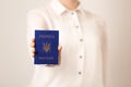 Woman holding Ukrainian internal passport on light background