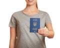 Woman holding Ukrainian travel passport against blurred background