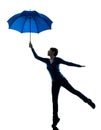 Woman holding umbrella wind blowing silhouette Royalty Free Stock Photo