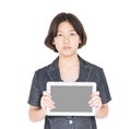 Woman holding up blank tablet computer