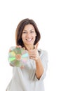 Woman holding up compact disc or cd and looking at camera with t Royalty Free Stock Photo