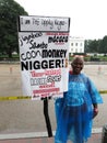 Woman Holding up Protest Sign Against Racial Slurs