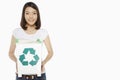 Woman holding up a recycling bin filled with plastic bottles Royalty Free Stock Photo