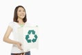 Woman holding up a recycling bin filled with plastic bottles Royalty Free Stock Photo