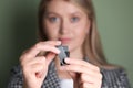 Woman holding usb flash drive against green background, focus on hands Royalty Free Stock Photo