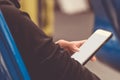 Woman holding and using mobile smartphone to connect airport wifi internet to searching for information while waiting for flight Royalty Free Stock Photo