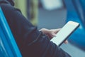 Woman holding and using mobile smartphone to connect airport wifi internet to searching for information while waiting for flight Royalty Free Stock Photo