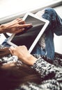 Woman holding and using tablet with empty screen