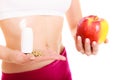 Woman holding vitamins and apple. Health care. Royalty Free Stock Photo