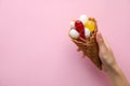 Woman holding wafer cone with delicious lollipop candies on pink background. Space for text Royalty Free Stock Photo