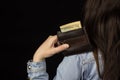 Woman holding a wallet with money, close-up, Black background, banknote, dollars Royalty Free Stock Photo