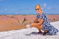 Woman holding white foam  near orange salt lake Royalty Free Stock Photo