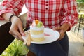 Woman holding a white plate, vanilla cake, kiwi, strawberry, morning, cake concept, bakery Royalty Free Stock Photo