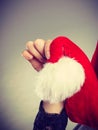 Woman holding white pompon on Santa hat