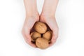 Woman holding whole walnut in her hands. Walnut isolated. Walnut, healthy organic food concept. Top view. View above Royalty Free Stock Photo