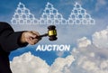 Woman holding a wooden hammer in a suit pointing out to the bidders, and a house icon on a sky background, With concept