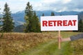 Woman holding wooden sign with word Retreat and beautiful view of mountain landscape Royalty Free Stock Photo