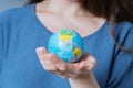 Woman holding world globe in her hands Royalty Free Stock Photo