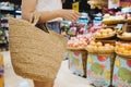 Woman holding a woven bag from Natural materials, shopping at local markets in Thailand, using natural renewable materials and