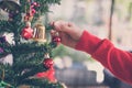 woman holding xmas ornament. girl decorate Christmas tree in a h Royalty Free Stock Photo