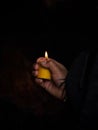 Woman holding burning candle in her hands memory grief religion faith belief in Las Lajas Sanctuary Ipiales Colombia