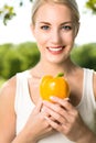 Woman holding yellow pepper