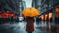 A Woman is holding a yellow umbrella and walking on a city street. Rainy weather.