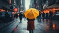 A Woman is holding a yellow umbrella and walking on a city street. Rainy weather.