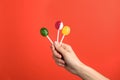 Woman holding yummy candies on color background Royalty Free Stock Photo