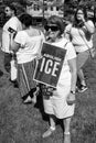 Woman Holds Abolish Ice sign at Immigration Rally