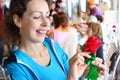 Woman holds artificial red rose Royalty Free Stock Photo