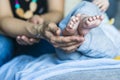 A woman holds a baby`s little feet Royalty Free Stock Photo