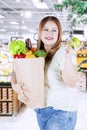 Woman holds a bag with vegetables Royalty Free Stock Photo