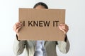 A woman holds a banner with the inscription I KNEW IT Royalty Free Stock Photo