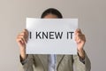 A woman holds a banner with the inscription I KNEW IT Royalty Free Stock Photo