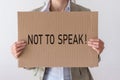 A woman holds a banner with the inscription NOT TO SPEAK Royalty Free Stock Photo