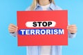 Woman holds banner with text Stop Terrorism Royalty Free Stock Photo