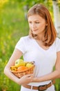 Woman holds basket with fruit