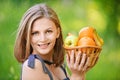 Woman holds basket with fruit