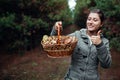 Woman Holds Basket Of Oily Mushrooms In Autumn Forest. Picking Up Fresh Organic Slippery Jack Mushrooms