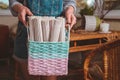 Woman holds basket with sets for basketmaker