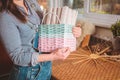 Woman holds basket with sets for basketmaker