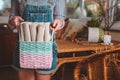 Woman holds basket with sets for basketmaker